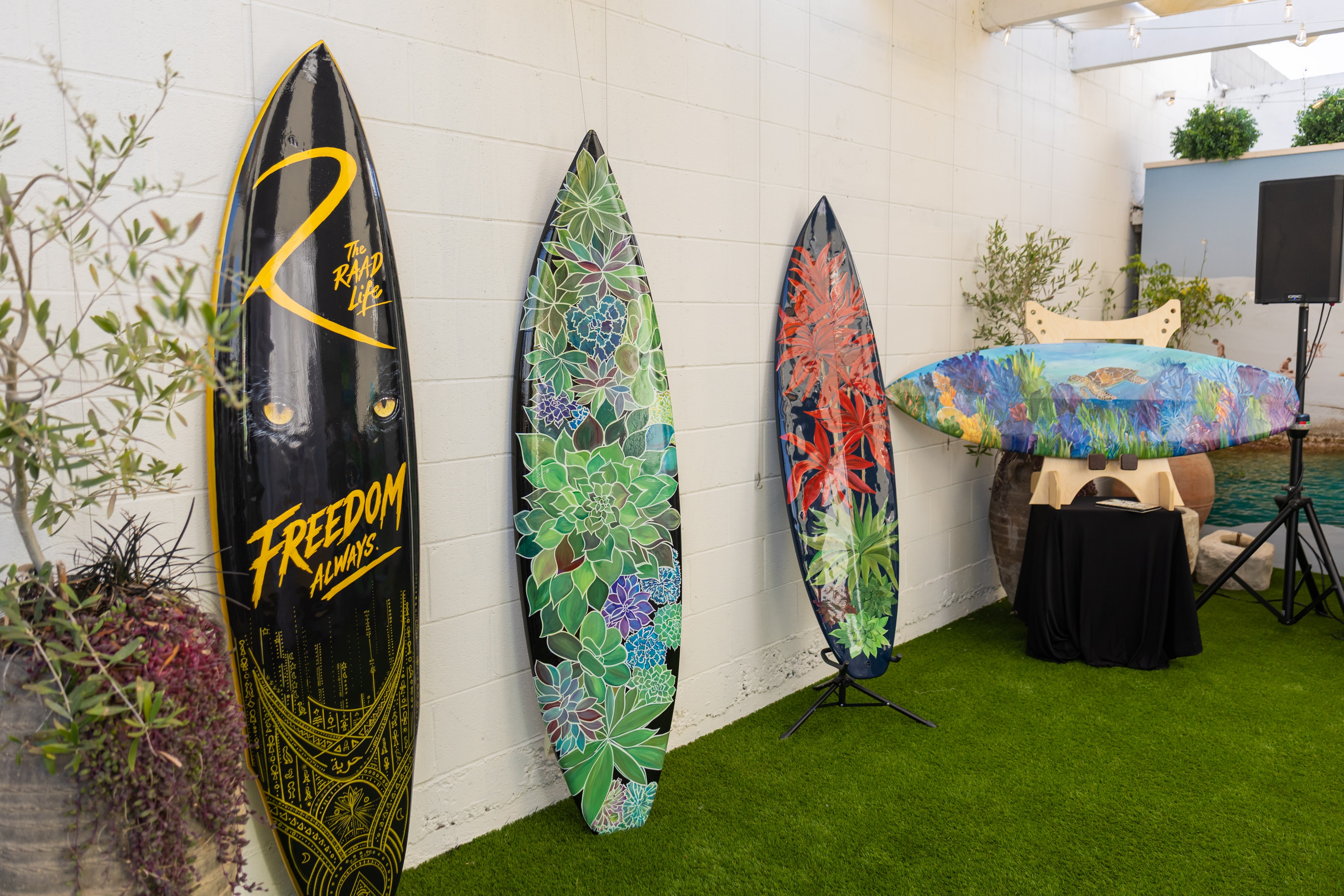 Hand-painted custom surfboards displayed at Shannon Paints event