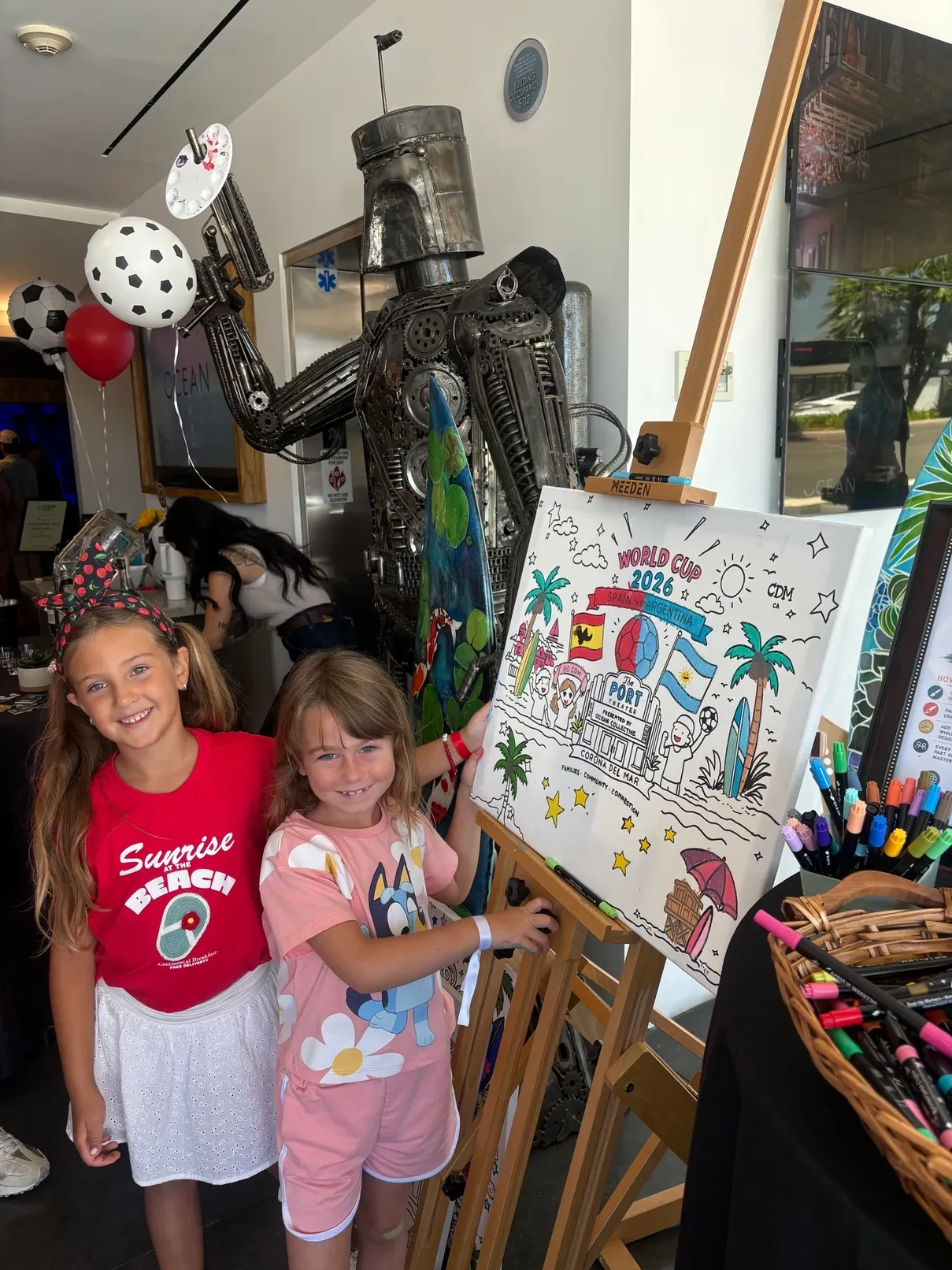 Two children posing with World Cup 2026 collaborative canvas at Shannon Paints event